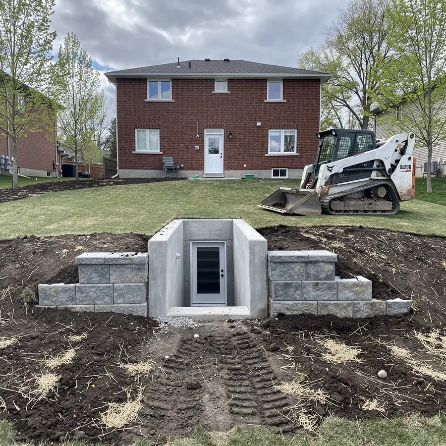 Completed basement walkout with armour stone walls
