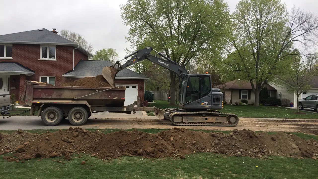 Excavator and dump truck beside Guelph home Excavator and dump truck beside Guelph home